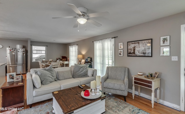 living room with ceiling fan and wood-type flooring