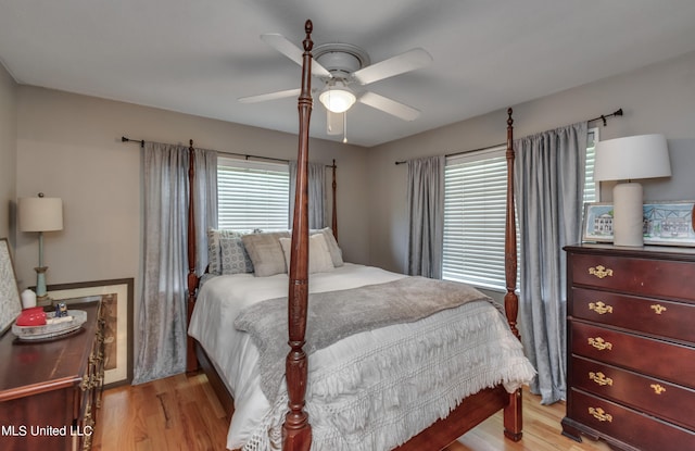 bedroom with ceiling fan and light hardwood / wood-style flooring