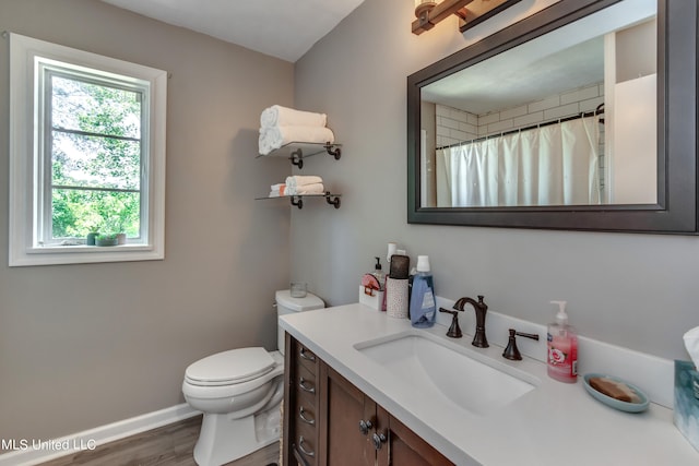 bathroom with vanity, hardwood / wood-style flooring, toilet, and walk in shower