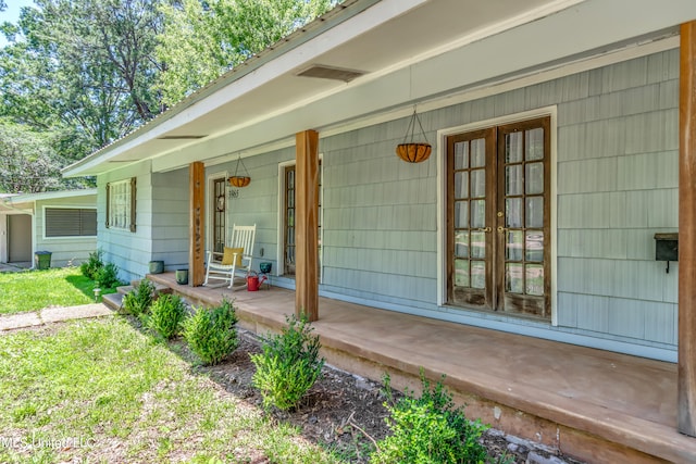 view of exterior entry featuring covered porch