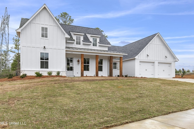 modern farmhouse with roof with shingles, a standing seam roof, a porch, board and batten siding, and a front yard