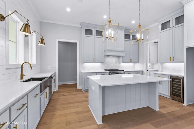 kitchen with glass insert cabinets, white cabinetry, and a kitchen island