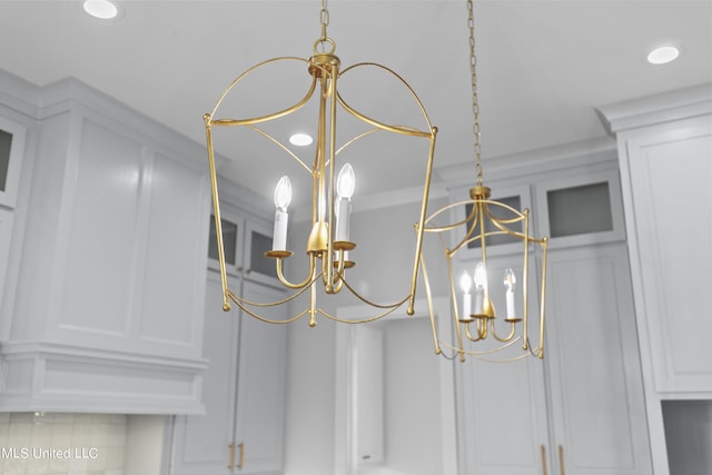 room details featuring a notable chandelier and recessed lighting