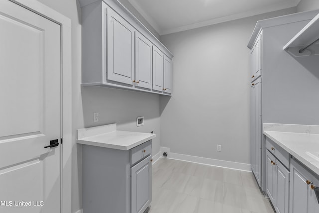 clothes washing area with washer hookup, cabinet space, ornamental molding, electric dryer hookup, and baseboards