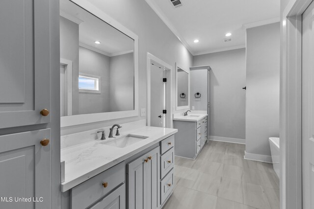 full bathroom with baseboards, ornamental molding, and a sink