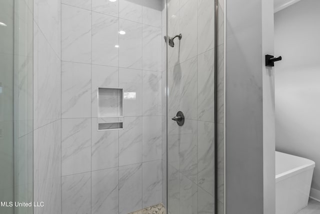 bathroom with a stall shower and a soaking tub