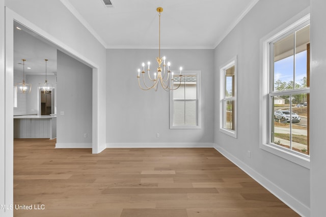 unfurnished dining area featuring a notable chandelier, visible vents, ornamental molding, wood finished floors, and baseboards