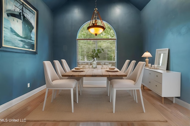 1400 Magnolia Bluff Dr, Gautier, MS 39553 - dining area featuring light wood-style flooring, baseboards, and high vaulted ceiling