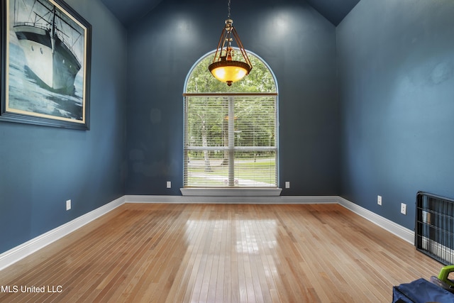 1400 Magnolia Bluff Dr, Gautier, MS 39553 - empty room featuring lofted ceiling, healthy amount of natural light, hardwood / wood-style flooring, and baseboards
