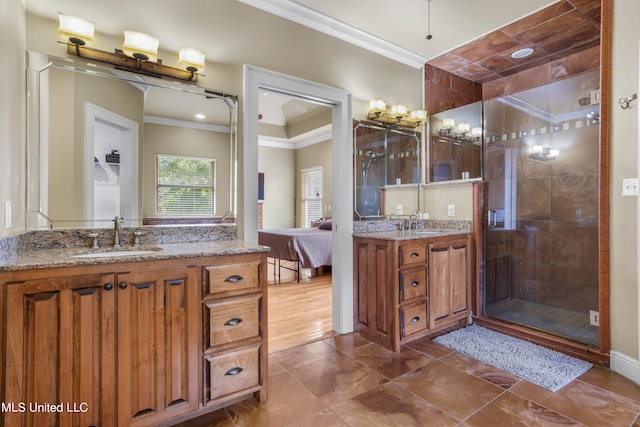 full bath with two vanities, a sink, ornamental molding, a stall shower, and ensuite bath