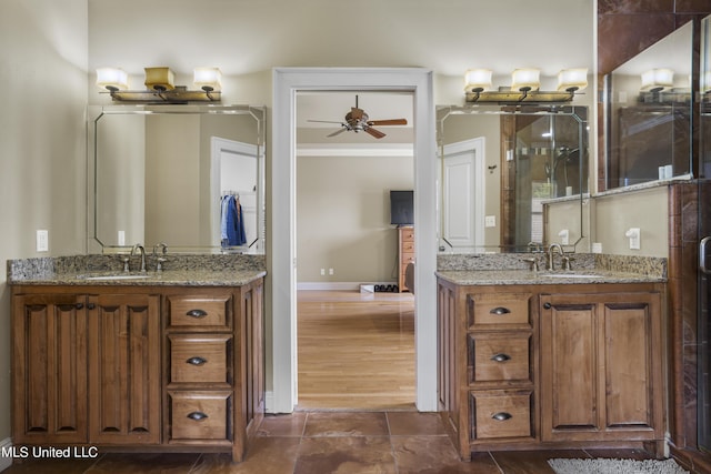 1400 Magnolia Bluff Dr, Gautier, MS 39553 - bathroom featuring ceiling fan, two vanities, baseboards, and a shower stall