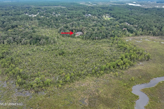 birds eye view of property with a wooded view