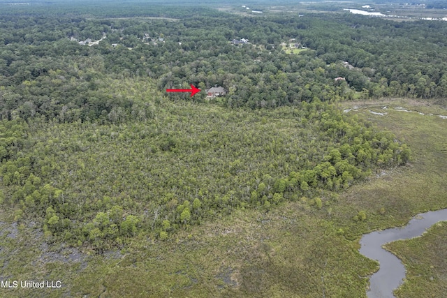 birds eye view of property featuring a view of trees