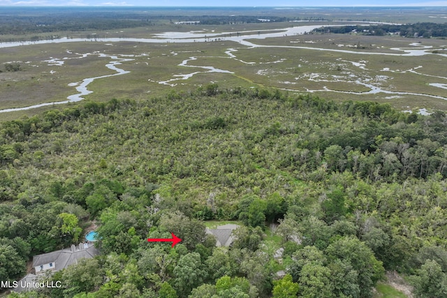 aerial view featuring a water view and a wooded view