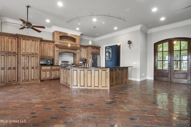 1400 Magnolia Bluff Dr, Gautier, MS 39553 - kitchen with french doors, dark countertops, a kitchen island with sink, baseboards, and appliances with stainless steel finishes