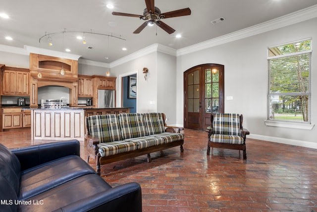 living room featuring plenty of natural light, baseboards, and visible vents