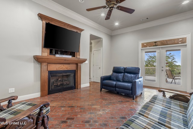 living room with brick floor, visible vents, crown molding, and baseboards