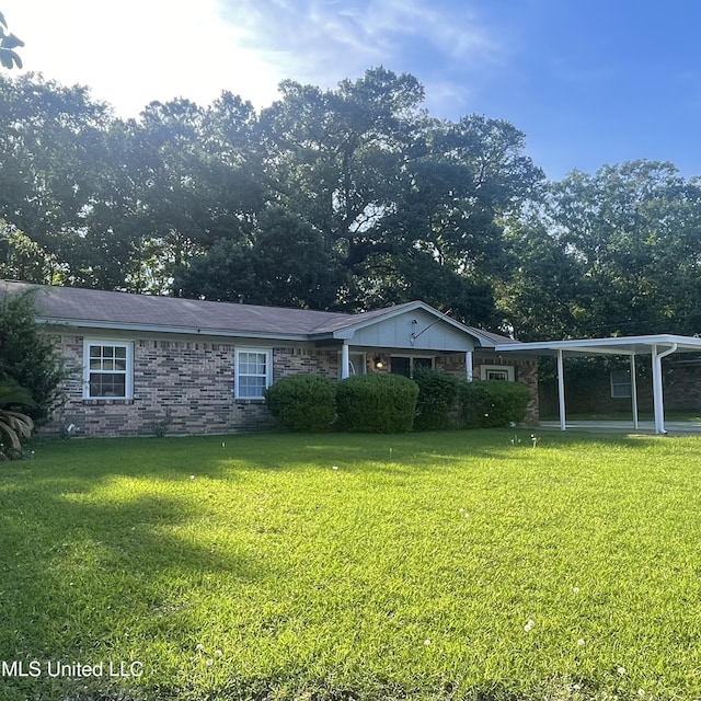109 Evergreen Dr, Diberville, MS 39540 - rear view of property featuring a yard and an attached carport