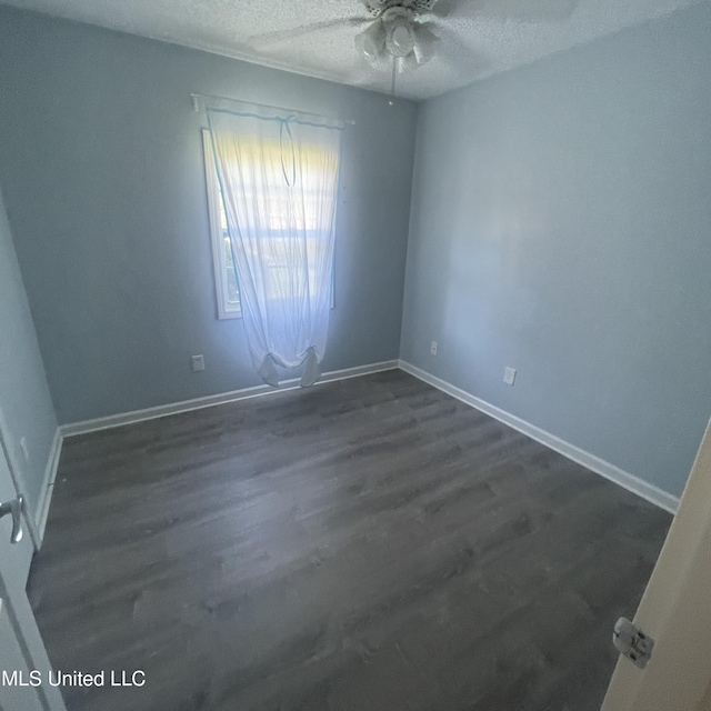 109 Evergreen Dr, Diberville, MS 39540 - unfurnished room with a ceiling fan, a textured ceiling, dark wood-style flooring, and baseboards