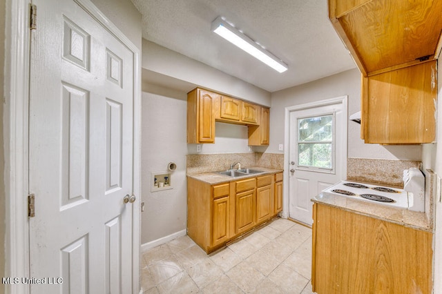 kitchen featuring white range and sink