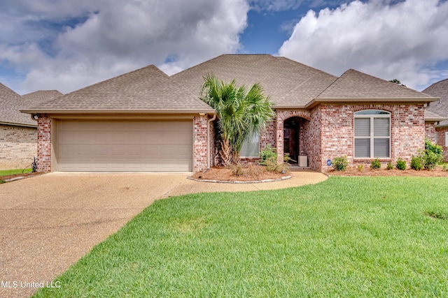 272 Hidden Hills Pkwy, Brandon, MS 39047 - view of front facade with a shingled roof, concrete driveway, brick siding, an attached garage, and a front lawn