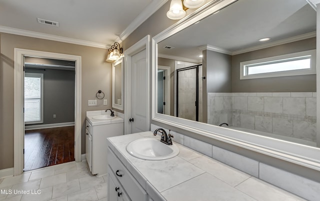 272 Hidden Hills Pkwy, Brandon, MS 39047 - bathroom featuring two vanities, ornamental molding, a shower stall, and a garden tub