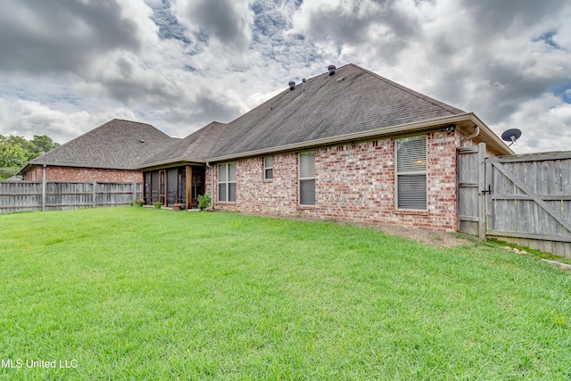 272 Hidden Hills Pkwy, Brandon, MS 39047 - back of house featuring brick siding, a fenced backyard, roof with shingles, and a sunroom