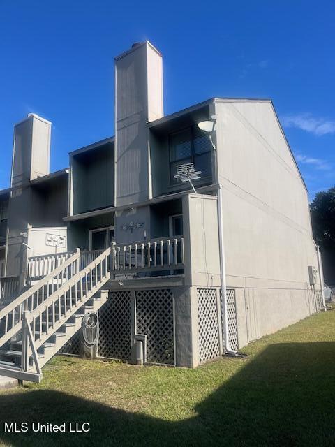 view of side of home featuring a lawn