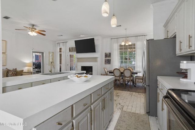 251 Greensview Dr, Brandon, MS 39047 - kitchen with open floor plan, a sink, a ceiling fan, light countertops, and gray cabinets