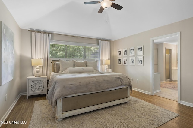 251 Greensview Dr, Brandon, MS 39047 - bedroom featuring vaulted ceiling, wood finished floors, baseboards, ensuite bathroom, and a ceiling fan