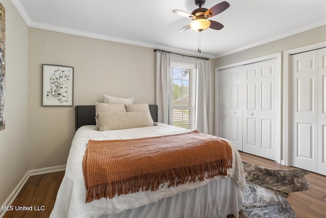 251 Greensview Dr, Brandon, MS 39047 - bedroom featuring wood finished floors, crown molding, baseboards, two closets, and ceiling fan