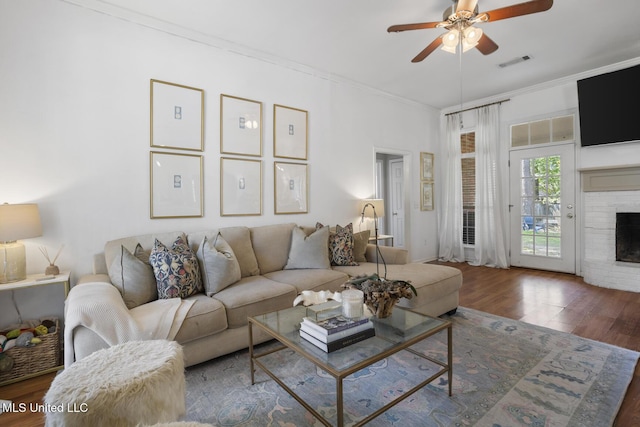 251 Greensview Dr, Brandon, MS 39047 - living room featuring ceiling fan, wood finished floors, a fireplace, and ornamental molding