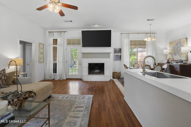 251 Greensview Dr, Brandon, MS 39047 - living area with crown molding, dark wood-style floors, plenty of natural light, and a fireplace