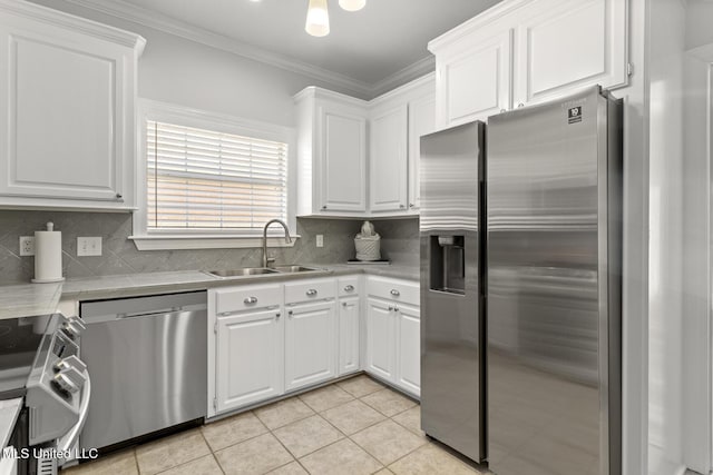 kitchen featuring crown molding, light countertops, appliances with stainless steel finishes, white cabinets, and a sink