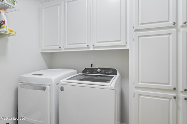 laundry room with cabinet space and washing machine and clothes dryer