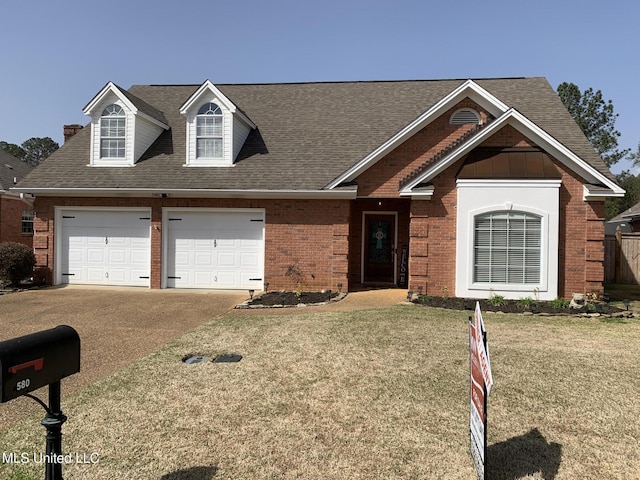 view of front of property featuring a front yard, concrete driveway, brick siding, and a shingled roof