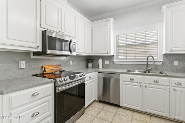 kitchen featuring a sink, stainless steel appliances, ornamental molding, and white cabinetry