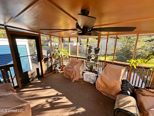 sunroom / solarium with ceiling fan and lofted ceiling