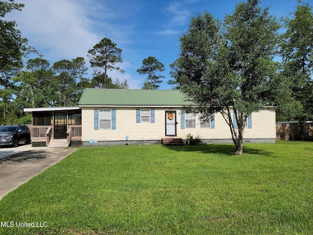 manufactured / mobile home with a front yard and a sunroom