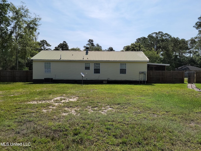 rear view of property featuring a yard