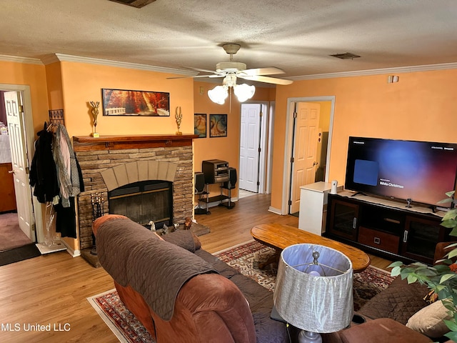 living room featuring a fireplace, light hardwood / wood-style flooring, and ornamental molding