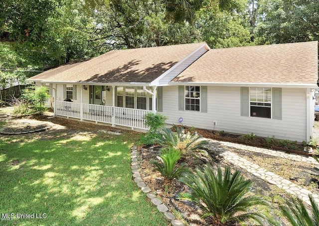 1154 E Old Pass Rd, Long Beach, MS 39560 - ranch-style home with covered porch, a front yard, and a shingled roof