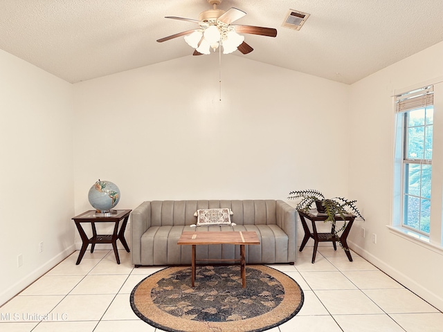 1154 E Old Pass Rd, Long Beach, MS 39560 - sitting room with light tile patterned flooring, plenty of natural light, vaulted ceiling, ceiling fan, and a textured ceiling