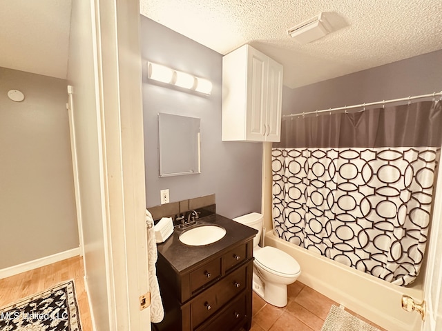 1154 E Old Pass Rd, Long Beach, MS 39560 - full bath featuring vanity, toilet, shower / tub combo with curtain, and a textured ceiling