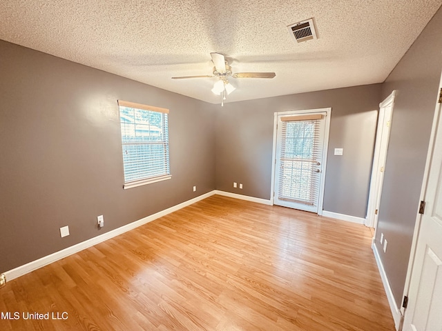 1154 E Old Pass Rd, Long Beach, MS 39560 - unfurnished room with a textured ceiling, a ceiling fan, light wood-style floors, and baseboards