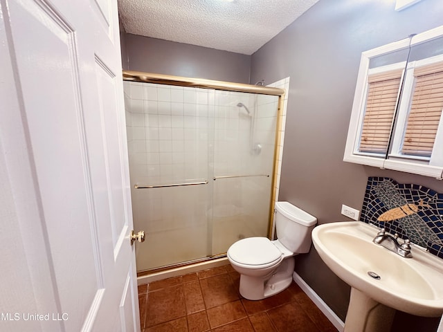 1154 E Old Pass Rd, Long Beach, MS 39560 - full bathroom with toilet, a shower stall, a textured ceiling, tile patterned floors, and a sink