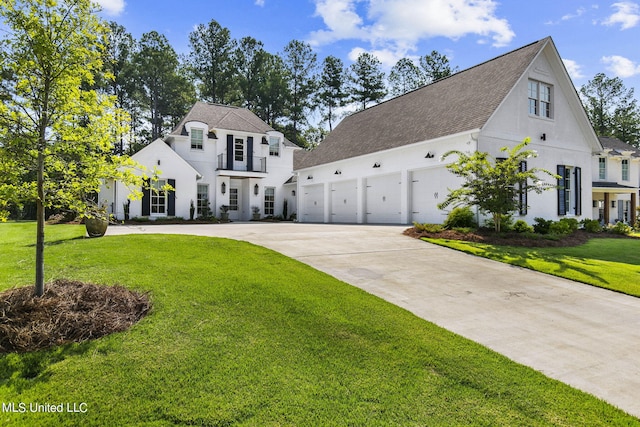 view of front of property with a garage and a front lawn