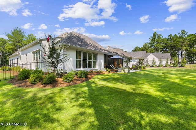 back of house with a lawn