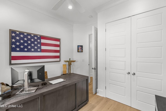 home office featuring light wood-type flooring, ceiling fan, and ornamental molding