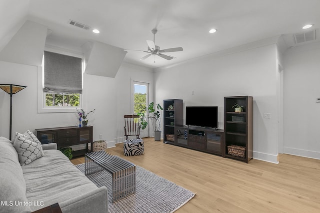 living room with ceiling fan, ornamental molding, and light hardwood / wood-style flooring